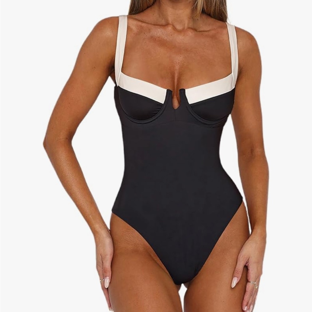 Sophisticated Black and Cream One-Piece Swimsuit with High-Leg Cut
